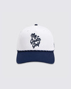 A structured baseball cap with a white crown and a navy blue curved brim. The front of the crown features the text 'Me Gusta Golf' embroidered in dark navy blue script.